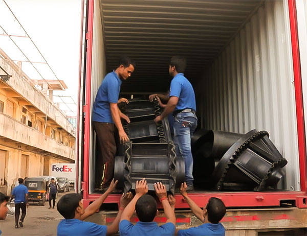 bucket elevator conveyor belt being loaded into shipping container truck.