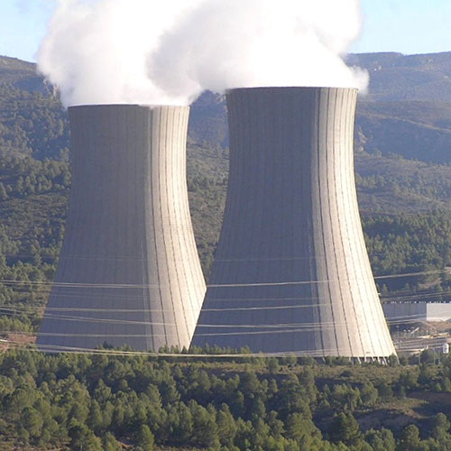 nuclear power plants in distance and forest.