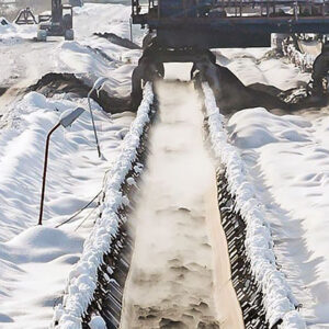 heavy stones being carried on Cold resistant conveyor belt. in hard cold snow Environment