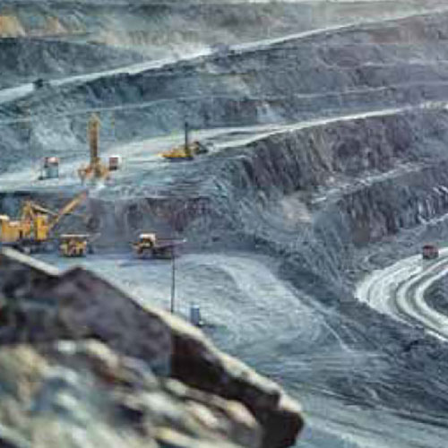 excavators working on a very large mining site.