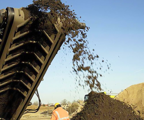 chevron conveyor belt piling stones on a heap